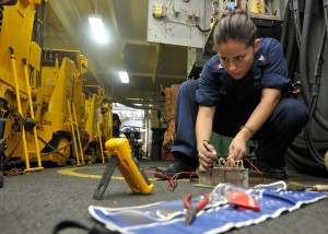 110723-N-EE987-125 GULF OF ADEN (July 23, 2011) ElectricianÕs Mate 2nd Class Maria Arreedondo, from Houston, uses a flow divider while fixing a forklift battery charging station in the hangar bay of the aircraft carrier USS Ronald Reagan (CVN 76). Ronald Reagan is conducting operations supporting maritime security operations and theater security cooperation efforts in the U.S. 5th Fleet area of responsibility. (U.S. Navy photo by Mass Communication Specialist 3rd Class Shawn J. Stewart/Released)