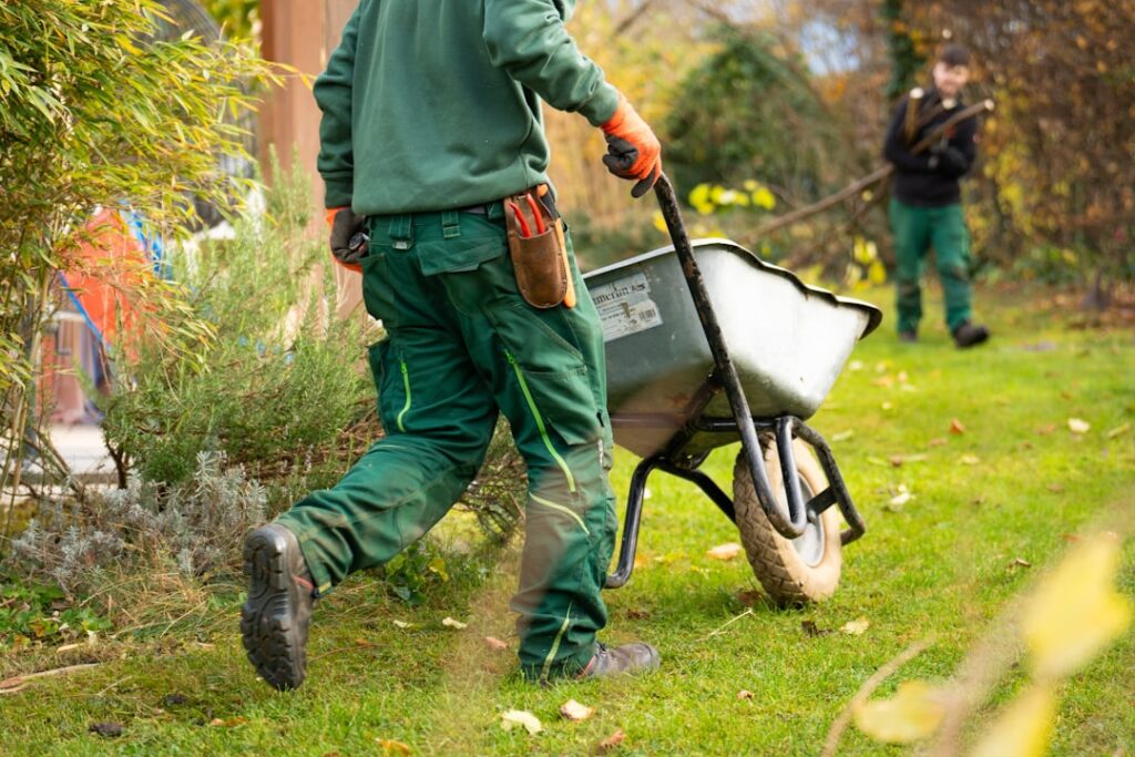 A man pulling a wheelbarrow with a wheel