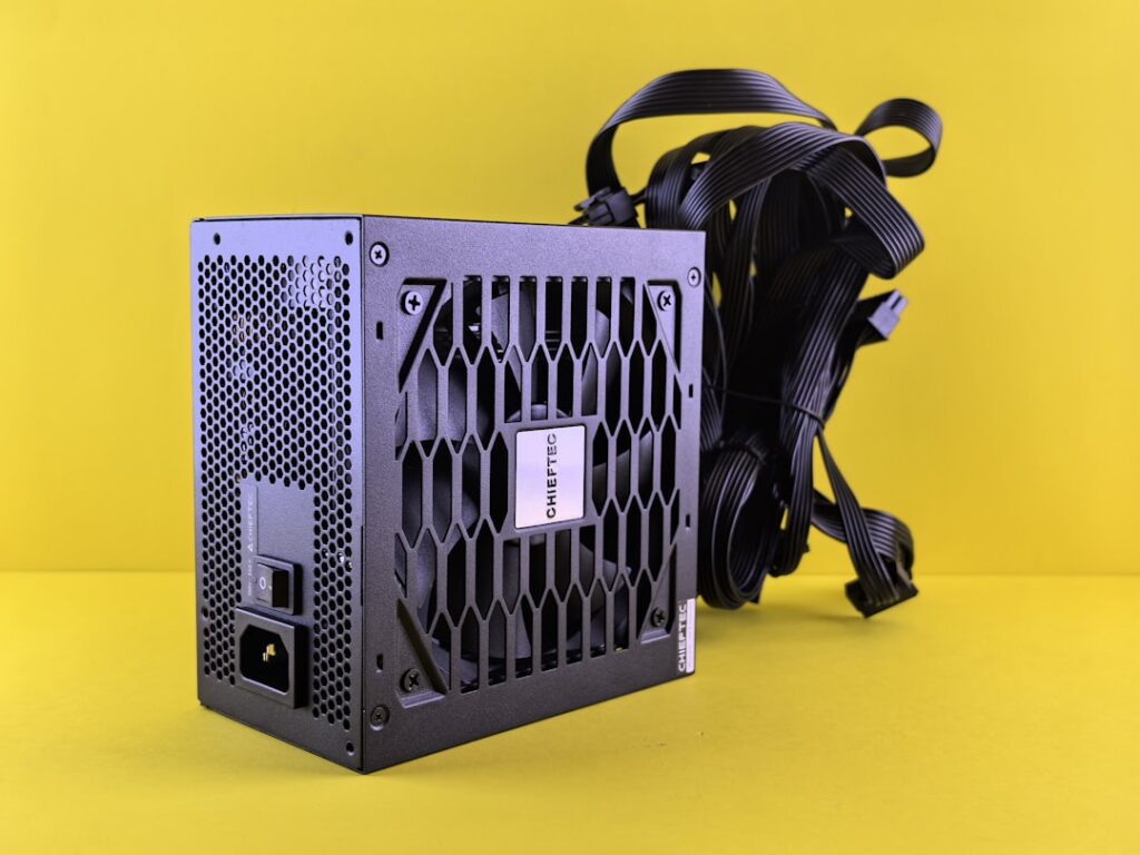 A black computer case sitting on top of a yellow surface