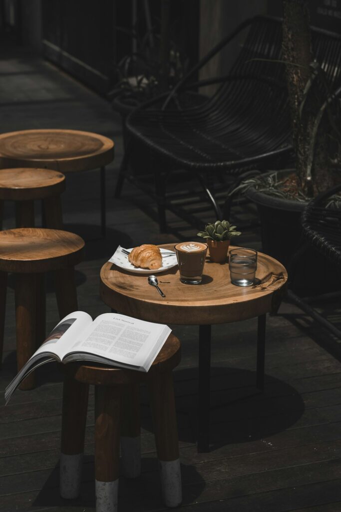 latte croissant and book on cafe table