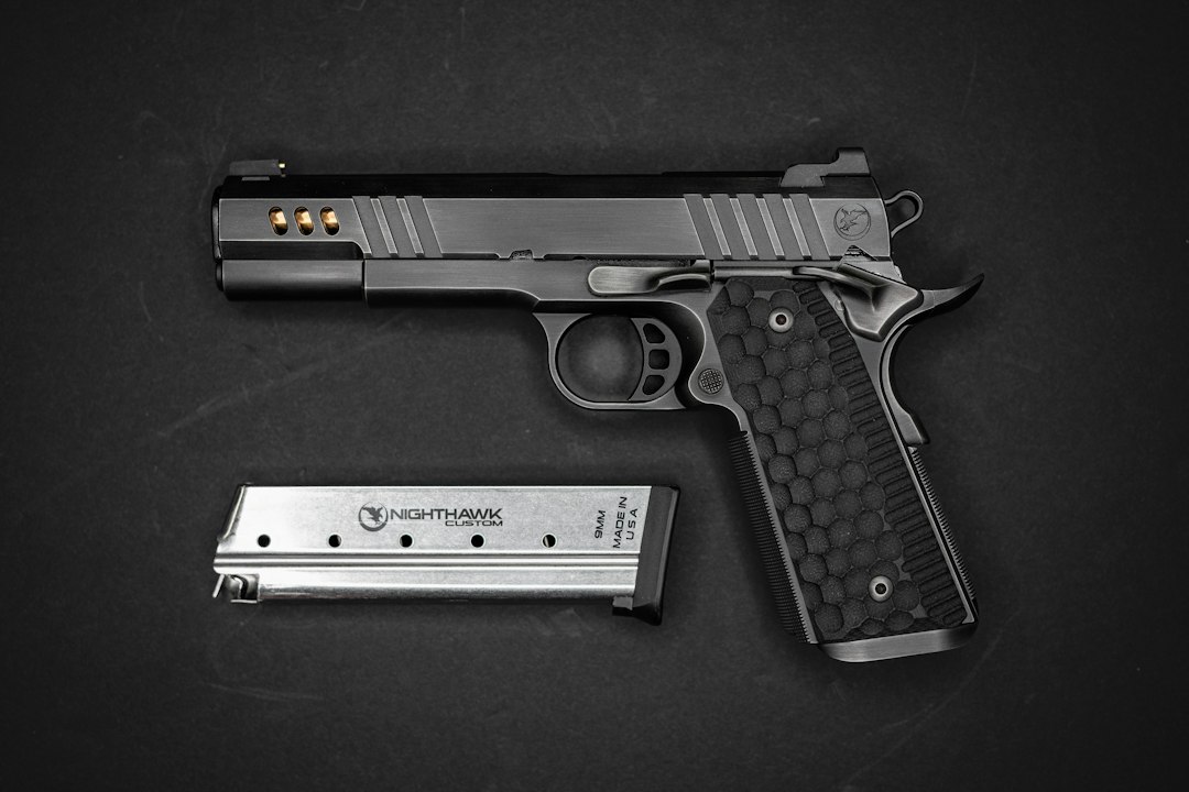 A black semi-automatic pistol with a textured grip and a metal magazine